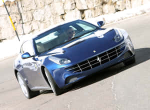 Sleek And Powerful Ferrari Ff Accelerating On The Road Wallpaper