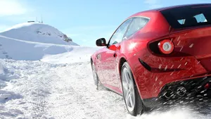 Sleek And Powerful Ferrari Ff On Open Road Wallpaper