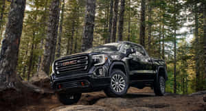 Sleek And Powerful Gmc Yukon In A Scenic Environment Wallpaper