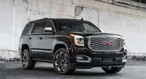 Sleek And Powerful Gmc Yukon On A Scenic Drive Wallpaper