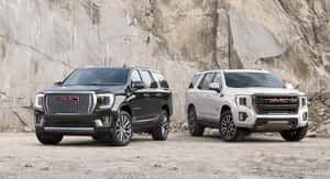 Sleek And Powerful Gmc Yukon On The Road Wallpaper