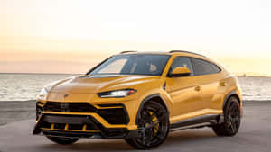 Sleek And Powerful Lamborghini Urus In Action Wallpaper