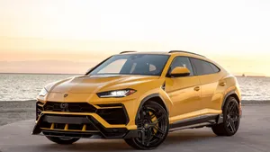 Sleek And Powerful Lamborghini Urus In Action Wallpaper
