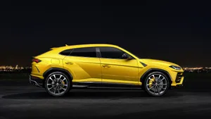 Sleek And Powerful Lamborghini Urus In Stunning Scenery Wallpaper