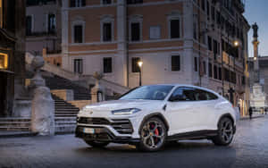 Sleek And Powerful Lamborghini Urus Suv In Action Wallpaper