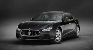 Sleek And Powerful Maserati Ghibli Cruising Down The Highway Wallpaper