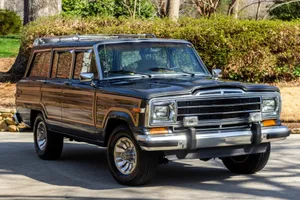 Sleek And Rugged Jeep Wagoneer On A Scenic Mountain Adventure Wallpaper