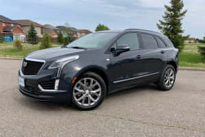 Sleek And Sophisticated Cadillac Xt5 On Scenic Drive Wallpaper