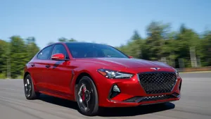 Sleek And Sophisticated Genesis G70 In Urban Setting Wallpaper
