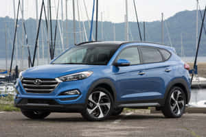 Sleek And Sophisticated Hyundai Tucson On The Road Wallpaper