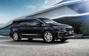 Sleek And Spacious Kia Sedona On Scenic Road Wallpaper