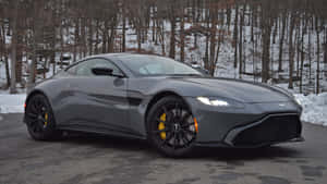 Sleek And Stunning Aston Martin Vantage On The Open Road Wallpaper