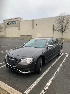 Sleek And Stunning Chrysler 300 On A Scenic Road Wallpaper