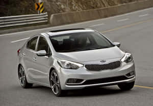 Sleek And Stunning Kia Forte Under The Lights Wallpaper