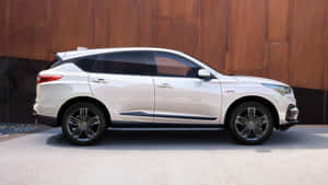 Sleek And Stylish Acura Rdx On The Road Wallpaper