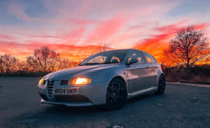 Sleek And Stylish Alfa Romeo 147 On A Scenic Road Wallpaper