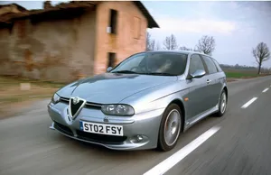 Sleek And Stylish Alfa Romeo 156 On The Road Wallpaper