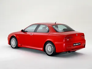 Sleek And Stylish Alfa Romeo 156 On The Road Wallpaper