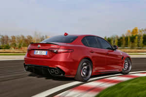 Sleek And Stylish Alfa Romeo Giulia In Motion Wallpaper