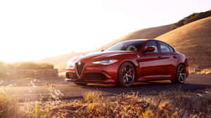 Sleek And Stylish Alfa Romeo Giulia On A Scenic Road Wallpaper