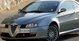 Sleek And Stylish Alfa Romeo Gt On The Road Wallpaper