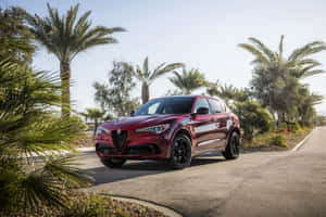 Sleek And Stylish Alfa Romeo Stelvio In Motion Wallpaper