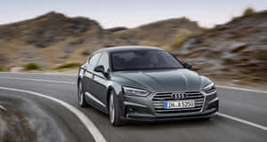 Sleek And Stylish Audi A5 In Motion Wallpaper