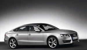 Sleek And Stylish Audi A5 On The Road Wallpaper