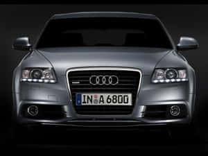 Sleek And Stylish Audi A6 On The Road Wallpaper