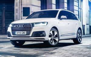 Sleek And Stylish Audi Q7 In Motion Wallpaper