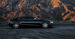 Sleek And Stylish Audi S5 Cruising On The Road Wallpaper