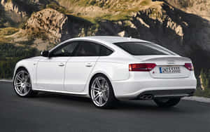 Sleek And Stylish Audi S5 In Motion Wallpaper