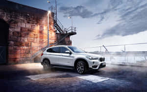 Sleek And Stylish Bmw X1 On The Road Wallpaper