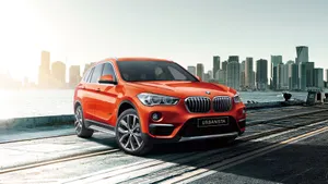Sleek And Stylish Bmw X1 On The Road Wallpaper