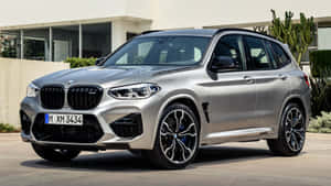 Sleek And Stylish Bmw X3 On Scenic Road Trip Wallpaper