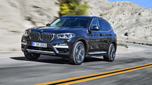 Sleek And Stylish Bmw X3 On The Road Wallpaper