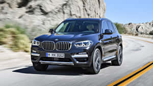 Sleek And Stylish Bmw X3 On The Road Wallpaper