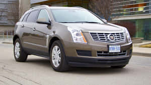 Sleek And Stylish Cadillac Srx On The Road Wallpaper