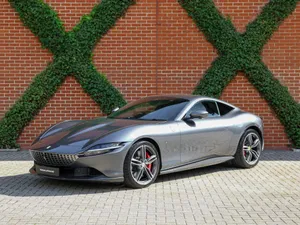 Sleek And Stylish Ferrari Roma In A Breathtaking Landscape Wallpaper