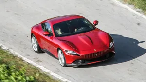 Sleek And Stylish Ferrari Roma On The Open Road Wallpaper