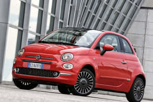 Sleek And Stylish Fiat 500 In Urban Landscape Wallpaper