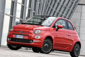 Sleek And Stylish Fiat 500 In Urban Landscape Wallpaper