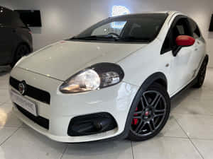 Sleek And Stylish Fiat Punto In Action Wallpaper