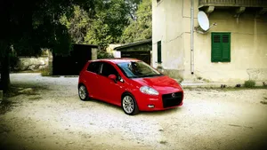 Sleek And Stylish Fiat Punto On The Road Wallpaper