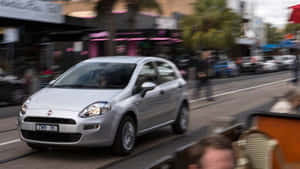 Sleek And Stylish Fiat Punto On The Road Wallpaper