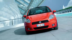 Sleek And Stylish Fiat Punto On The Road Wallpaper