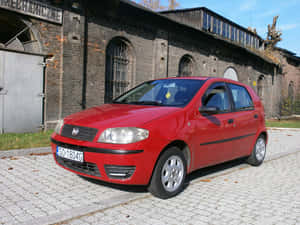 Sleek And Stylish Fiat Punto On The Road Wallpaper