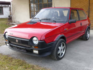 Sleek And Stylish Fiat Ritmo On The Road Wallpaper