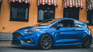 Sleek And Stylish Ford Fiesta On The Road Wallpaper