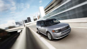 Sleek And Stylish Ford Flex On The Road Wallpaper